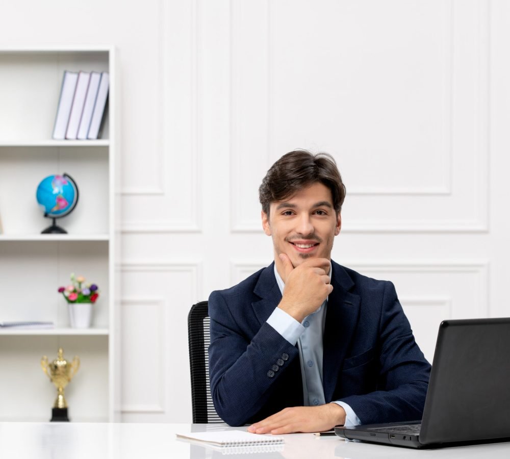 customer-service-cute-brunette-guy-suit-with-laptop-happy-touching-chin